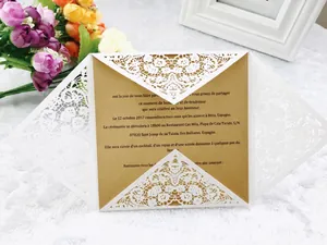 Detail of laser-cut white lace invitation cover with elegant brown kraft paper insert