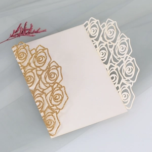 Detail of glitter gold laser cut rose invitation cover for wedding and event