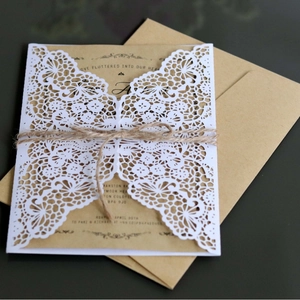 European laser-cut wedding invitation with kraft paper, lace design, and hemp rope bow
