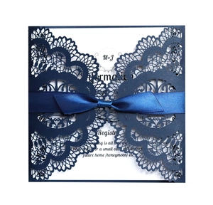 Navy blue laser cut wedding invitation with ribbon and lace pattern design