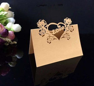 Macro detail of laser-cut heart and Love motif on vintage brown kraft paper table card