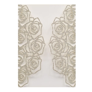 Detail of laser-cut rose hollow invitation cover with champagne gold glitter finish