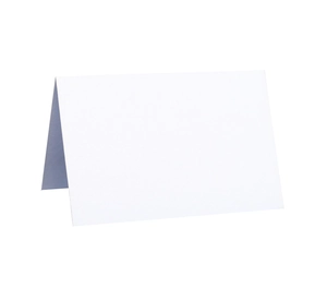 Close-up of white pearlescent paper table card with hollow laser-cut butterfly design