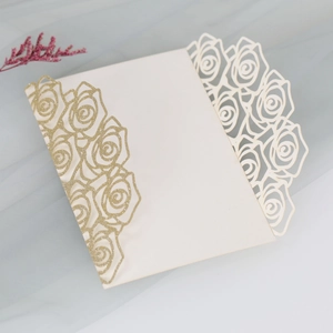 Detail of laser-cut rose card with gold glitter finish on cream white paper