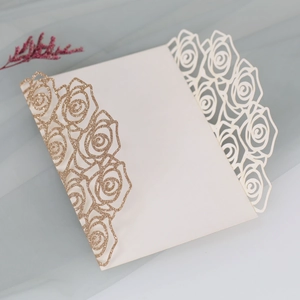 Detail view of champagne gold laser cut rose lace wedding invitation with glitter finish