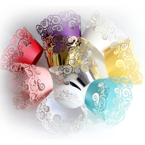Laser cut cupcake wrappers in assorted pearlescent colors with elegant vine patterns