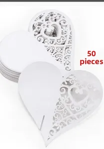 Pack of 50 laser-cut white heart place cards with intricate filigree pattern for weddings