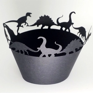 Dark green dinosaur cupcake wrappers featuring laser-cut prehistoric silhouettes for kids' parties