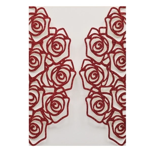 Detail of red glitter laser cut wedding invitations with elegant rose patterns