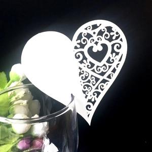 Elegant white heart laser-cut name place cards for wine glass decoration at weddings