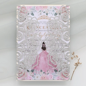 Macro detail of laser-cut glitter wedding invitation with rose pattern and silver finish
