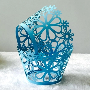 Laser-cut hollow flower cupcake wrappers in sky blue pearlescent paper for wedding decor