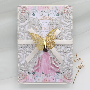 Detail of silver laser-cut rose invitation with golden butterfly and satin ribbon bow
