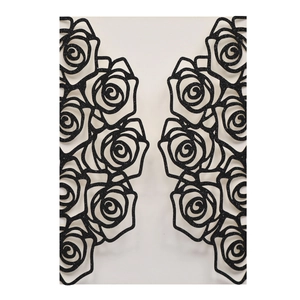 Macro detail of laser-cut black glitter paper wedding invitation with rose pattern
