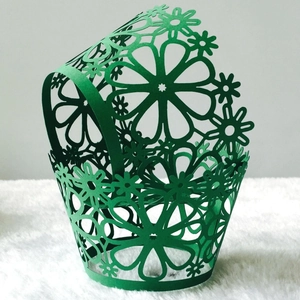 Laser-cut floral cupcake wrappers in vibrant green pearlescent paper for wedding decor