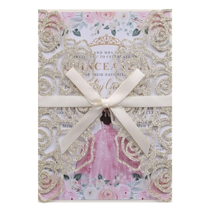 Detail of laser-cut gold glitter rose pattern and pink bow on wedding invitation