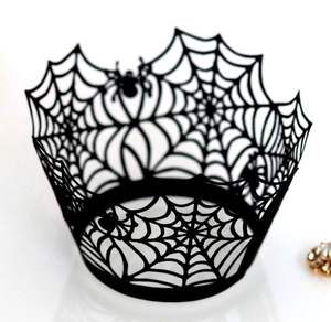 Close-up of laser-cut black spider web cupcake wrapper for Halloween party decoration