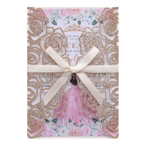 Detail of rose laser-cut wedding invitation with champagne glitter paper and satin bow