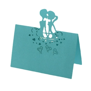 3D laser cut turquoise wedding place card with kissing couple silhouette and heart patterns
