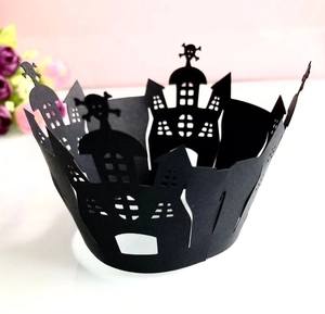 Intricate laser-cut Halloween cupcake wrappers featuring spooky skull and castle patterns