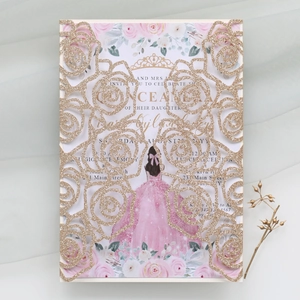 Detail of laser-cut gold glitter rose invitation with floral inner card and butterfly