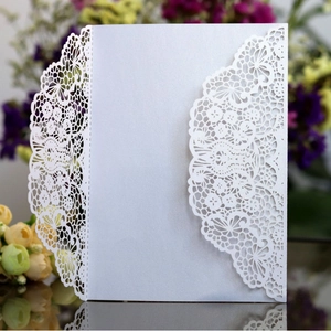 Elegant laser-cut lace wedding invitation with pearlescent finish and floral details
