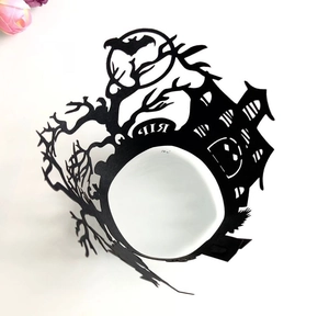 Laser-cut Halloween cupcake wrapper with black haunted castle and pumpkin designs