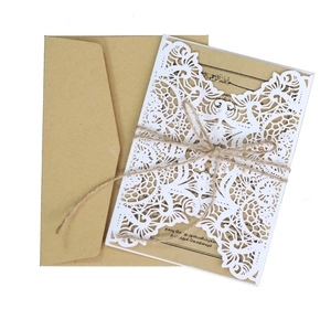 Close-up of laser-cut white lace sleeve with kraft paper insert and hemp rope bow