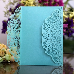 Elegant laser-cut lace wedding invitation in teal pearlescent paper with floral details