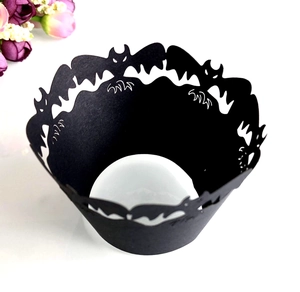 Laser-cut Halloween cupcake wrappers featuring black matte bat motifs and intricate cutouts