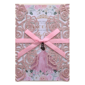 Detailed laser-cut rose invitation card with pink glitter finish and silk ribbon bow