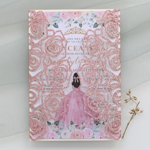 Detail of pink glitter laser-cut rose invitation card with gold foil text for Quinceañera