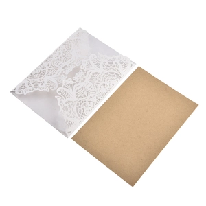 Detailed macro view of laser-cut lace wedding invitation with kraft paper card