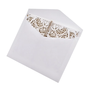 Elegant laser-cut floral wedding invitation set with white envelope and rustic jute rope