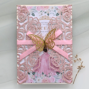 Macro view of laser-cut pink glitter rose invitation with golden butterfly detail