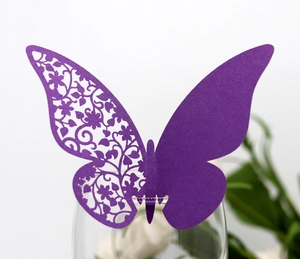 Macro detail of laser-cut purple butterfly card showing intricate floral lace patterns