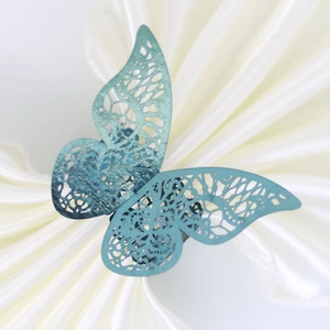 Exquisite hollow blue butterfly napkin ring crafted on luxurious white satin background
