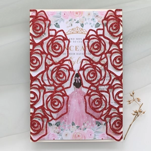 Macro shot of red glitter laser cut rose invitation with Quinceañera theme insert