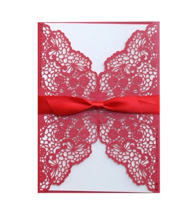 Red laser cut wedding invitation card with elegant lace pattern and satin ribbon bow