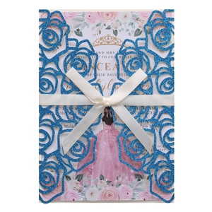 Laser-cut blue glitter wedding invitation card with pink floral insert and satin ribbon