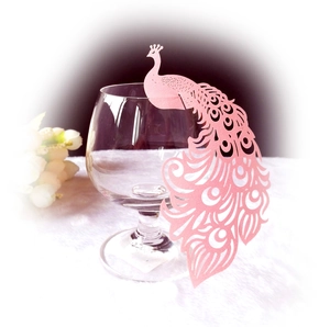 Pink peacock laser-cut paper cup cards for wedding party decor on transparent glass