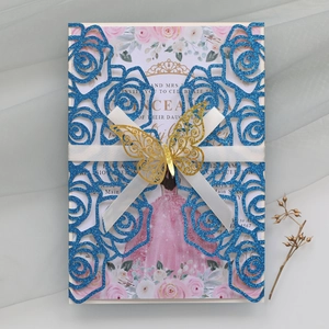 Detailed laser-cut glitter wedding invitation with blue roses and golden butterfly decoration