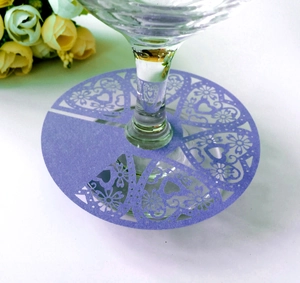 Detail of laser-cut purple heart place card with floral patterns on wine glass