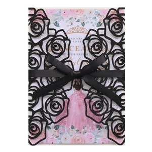 Detail of laser cut rose pattern wedding invitation with elegant black bow decoration