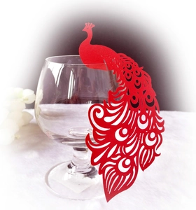 Detailed laser-cut red peacock glass card for wedding decorations on white background