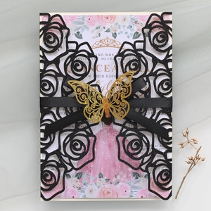 Detail of laser-cut black glitter wedding invitation with golden butterfly and satin ribbon
