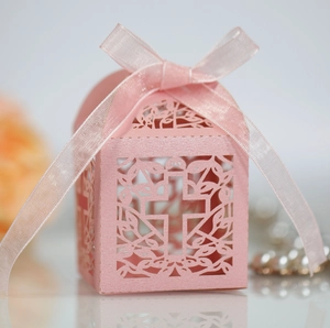 Pink laser cut wedding candy box with cross pattern and satin ribbon detail