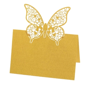 Elegant laser-cut golden butterfly place card with intricate heart hollow design