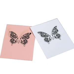 Elegant 3D laser cut butterfly place cards in pink and white for wedding table decor