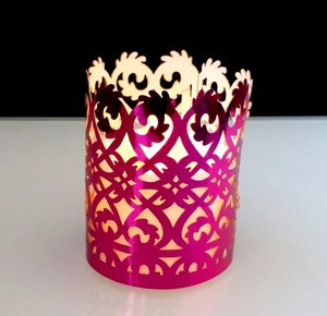 Detailed view of hollow rose gold candle shade with intricate laser-cut floral patterns